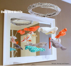 DIY Baby nursery crib mobile with a grapevine wreath nest frame and stuffed birds made of custom fabrics