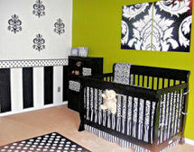 Black and white stripes painted on a baby girl nursery wall with a polka dot border