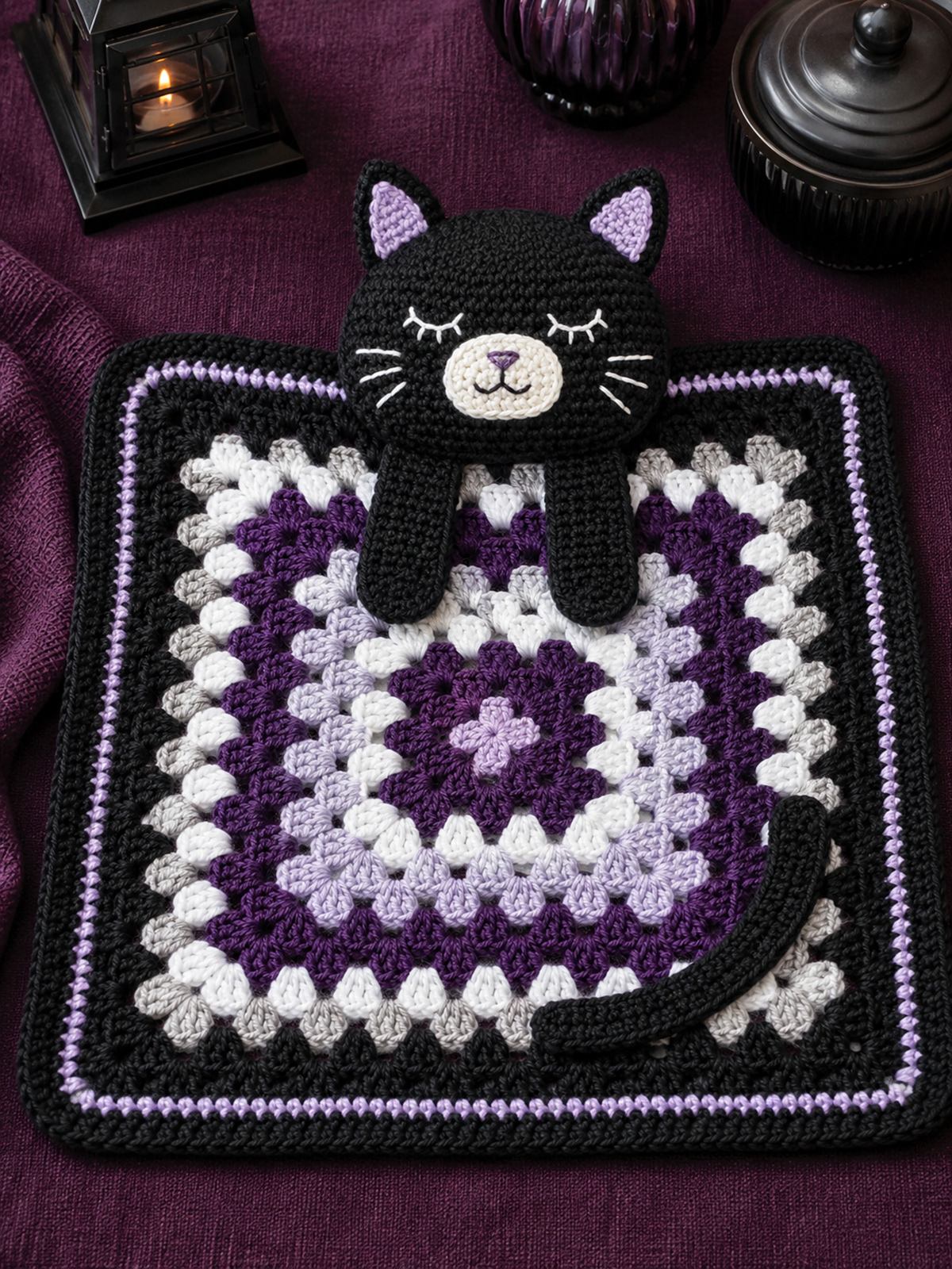Finished black cat crochet lovey with embroidered kitten face and attached granny-style baby blanket