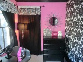 Pink black and white punk baby nursery room design for a girl in a punk theme with damask wallpaper
