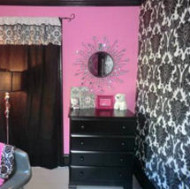 Black white and hot pink baby nursery with damask pattern wall