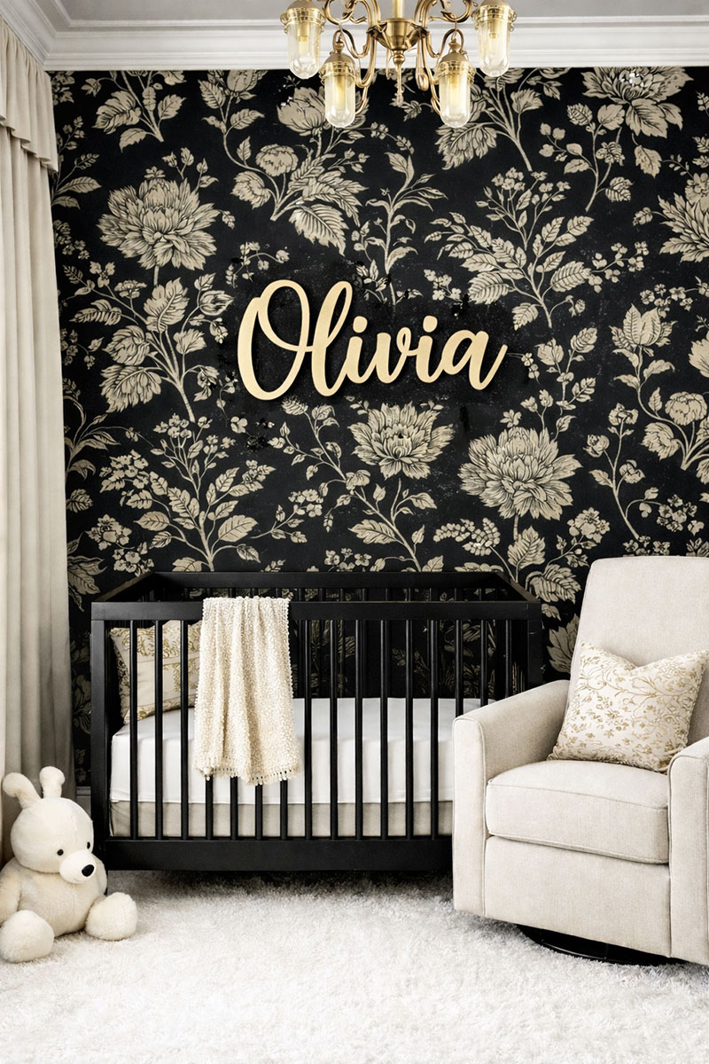Sophisticated black and white baby nursery with black crib, layered linens, and soft neutral textures