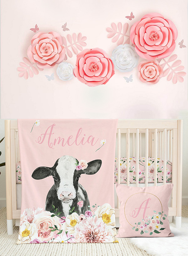 cow print baby crib bedding set for a girl nursery design in pink black and white