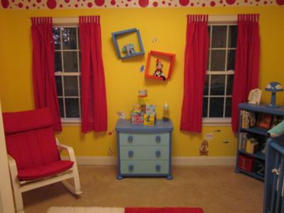 The topsy turvy wall plates decorate the wall between the red curtain panels in our baby boy's Dr Seuss theme nursery. 