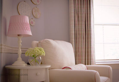 Baby girl Caroline Claire's pink and blue nursery with plaid curtain panels as window treatments