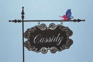 Personalized, black wrought iron street sign with my baby girl's name on it decorating the baby blue nursery walls