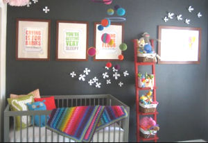 Neutral baby nursery with dark charcoal gray wall paint