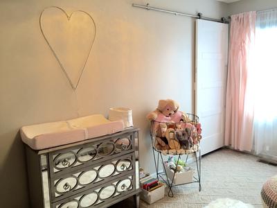 Sliding barn doors in a baby girl nursery