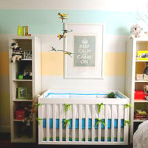 Aqua blue yellow and white gender neutral nursery with painted wall stripes