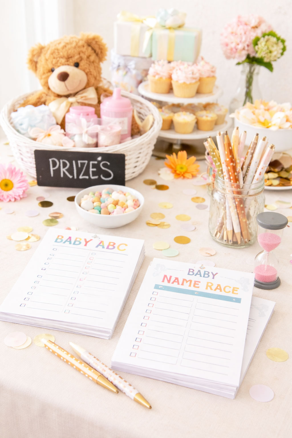 Classic baby shower games table setup with cards, pens, and simple party details