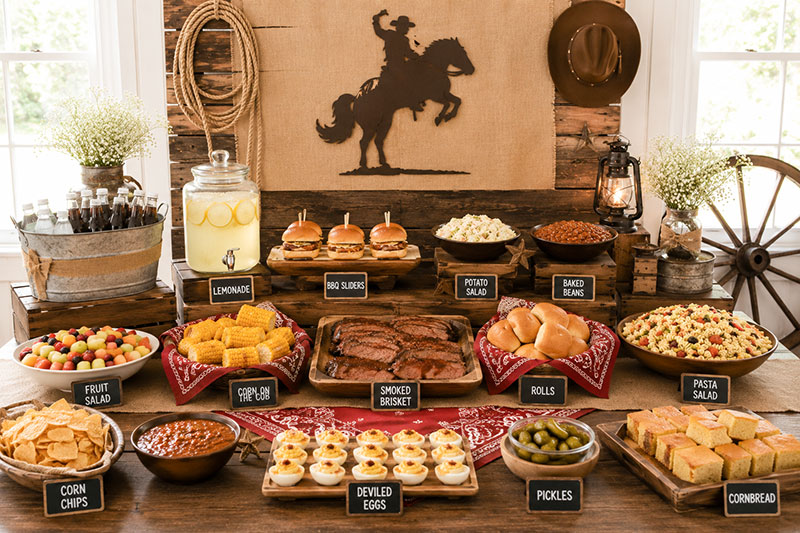 Cowboy baby shower food table with western themed food station and party buffet
