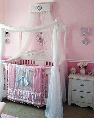 Pink Disney Princess baby nursery design with a baby bed canopy from SoZoeyBoutique and a homemade DIY crib canopy.