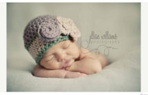 Purple, forest green and cream newborn baby girl chunky yarn baby beanie hat with large crochet flower pattern photo prop studio portrait