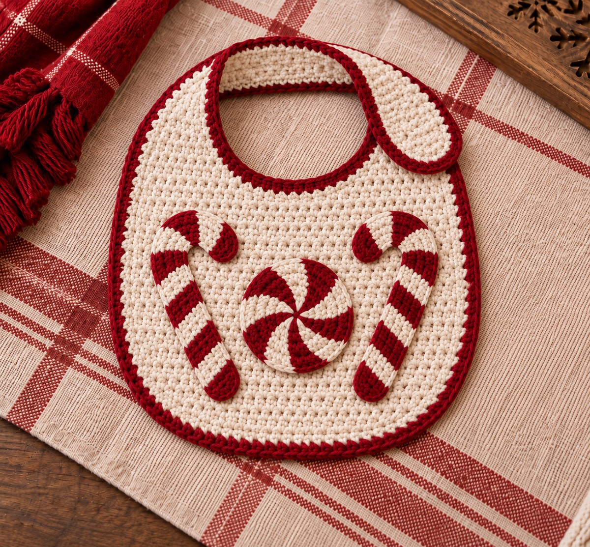 Free crochet candy cane and peppermint applique patterns on a cream crocheted baby bib