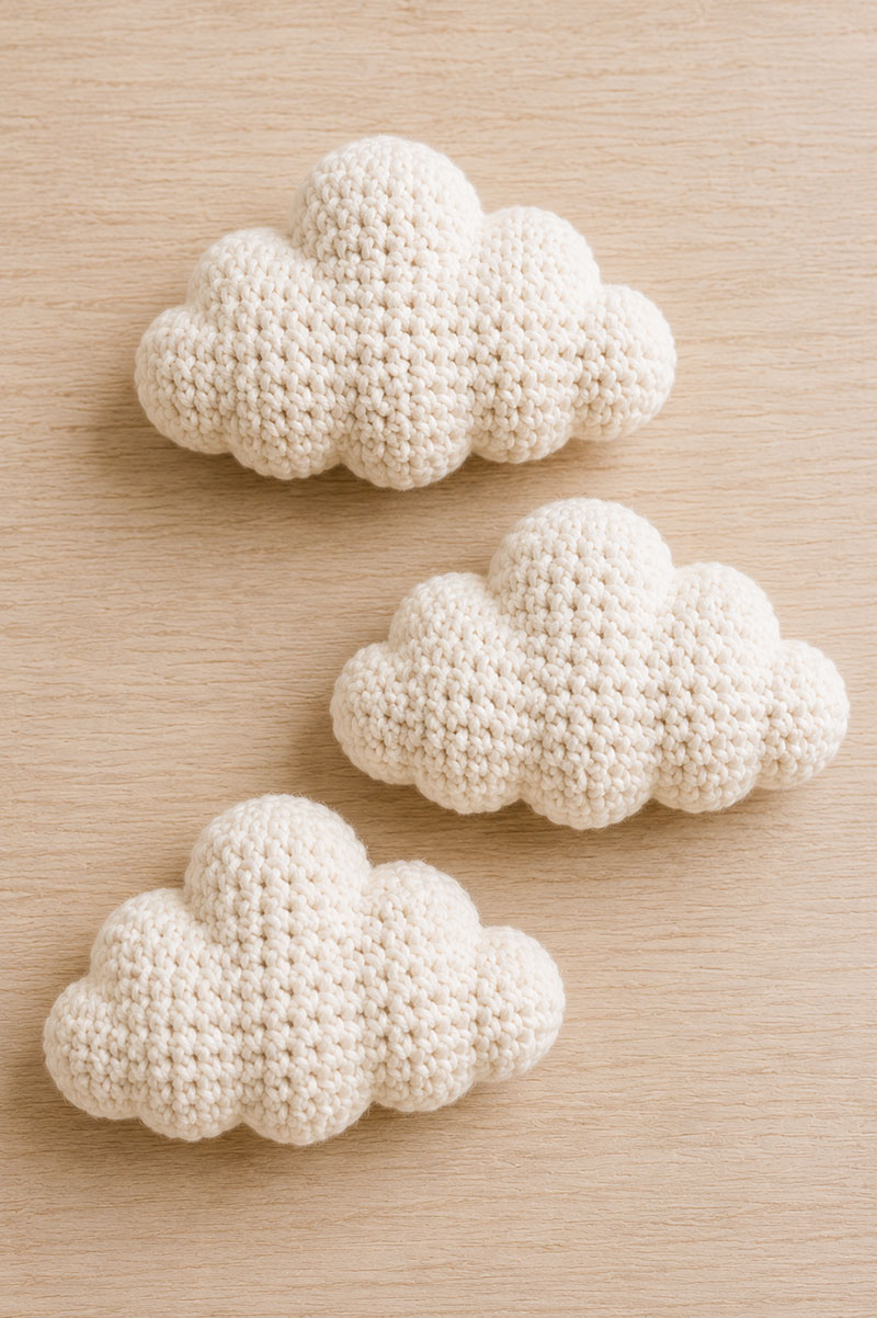 Crocheted nursery mobile clouds made from five stuffed crochet puffs