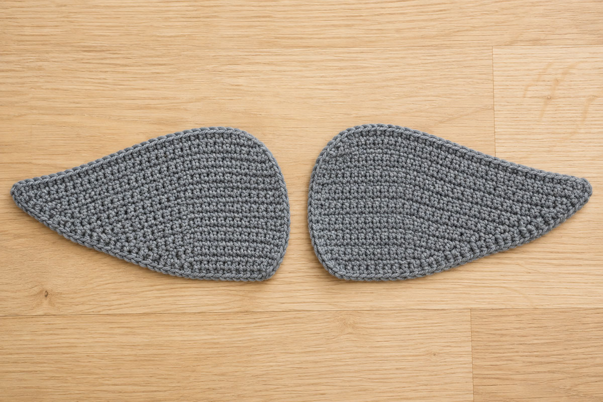 Two matching flat gray crochet mallard wing panels with rounded front edges and tapered rear points