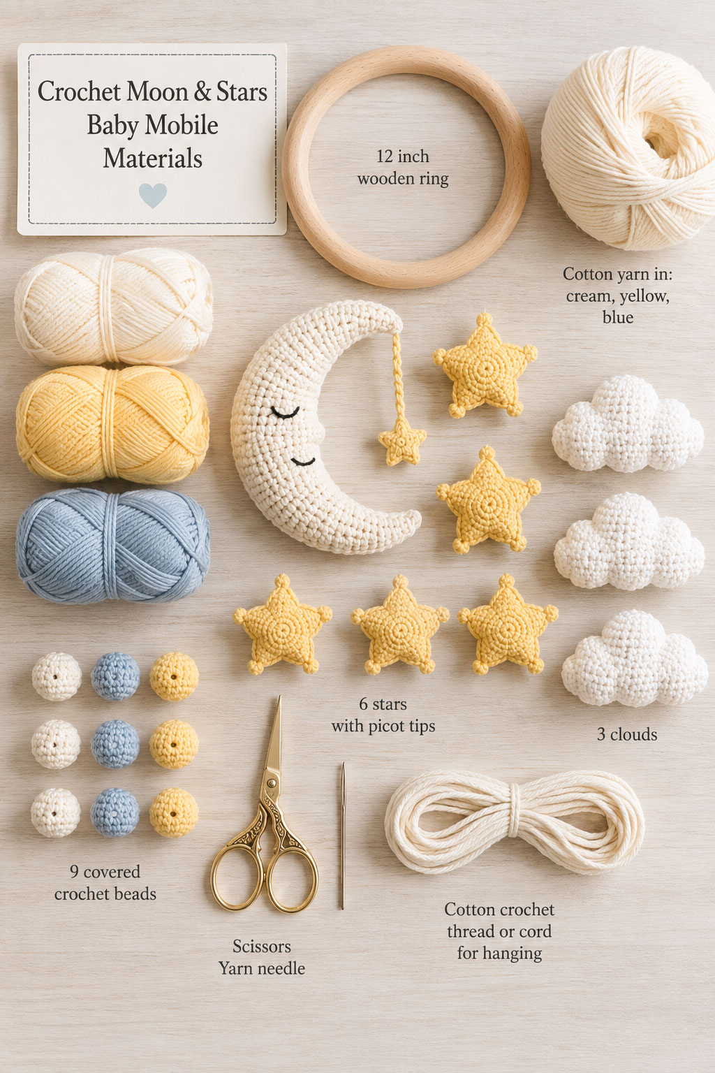 Crochet supplies arranged for a moon and stars baby mobile including cotton yarn, wooden ring, hook, stuffing and scissors