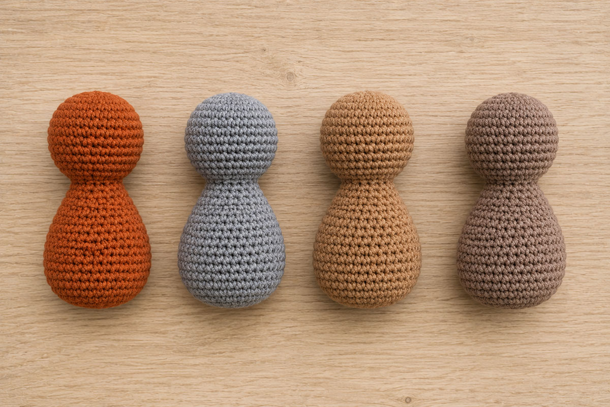 Four small crocheted woodland animal body shapes before ears faces and markings are added