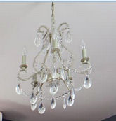 White crystal chandelier for a baby girl nursery room with tall ceilings