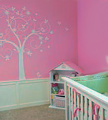 Tree decal stickers mural on the walls of a pink baby girl nursery