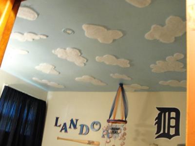 Cloud painting on a baby boy's sports nursery ceiling mural