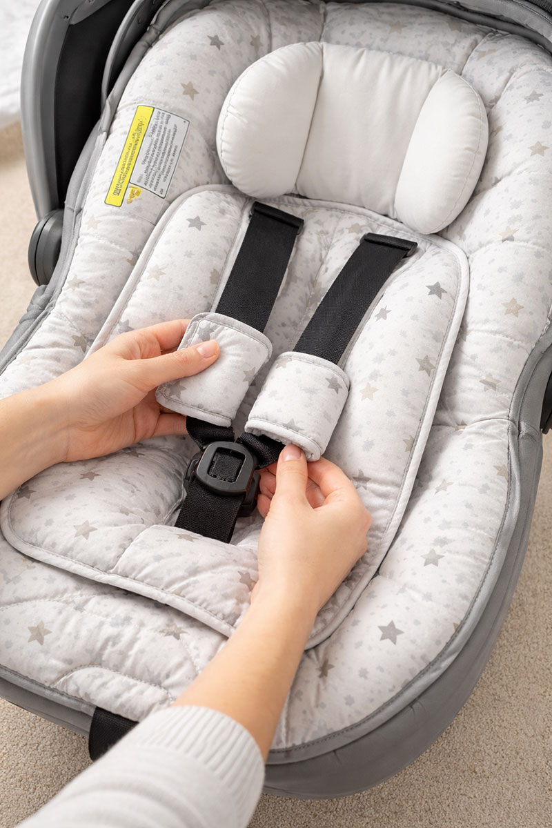 Checking harness access on a removable baby car seat cover