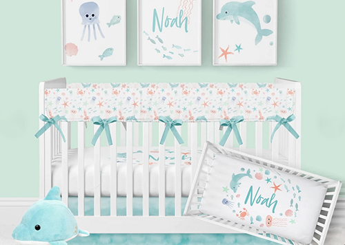 Dolphin ocean personalized baby boy nursery crib bedding set in aqua blue. Dolphin baby boy nursery theme design decor.