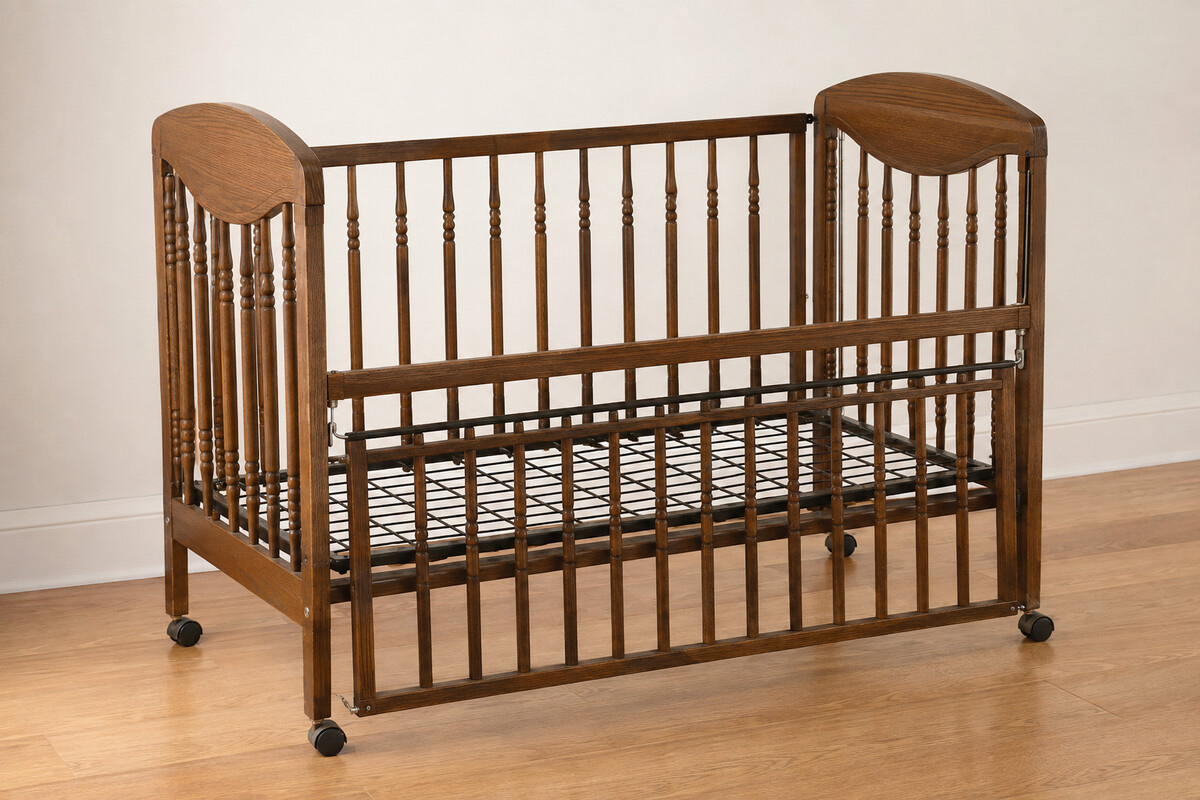 Older drop-side crib with a vertically moving side rail shown for identification