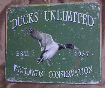 Vintage tin Ducks Unlimited mallard wall sign for a rustic baby boy nursery