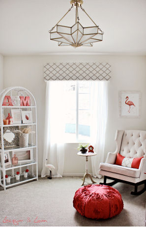 A modern nursery color scheme of taupe and cream with pops of bright coral