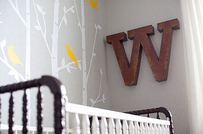 The iron wall letter adds a masculine personalized touch to the woodland themed nursery