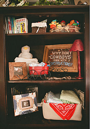Western baby boy cowboy theme nursery decorations on shelves