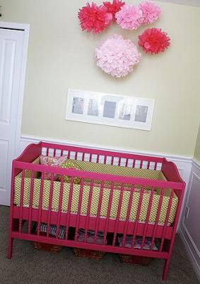 Recycled vintage Jenny Lind baby crib painted hot pink for a pink and green baby girl nursery room.