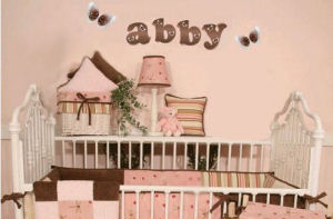 Pink and brown baby girl ladybug baby nursery crib bedding wooden wall letters and decor with vintage white iron bed