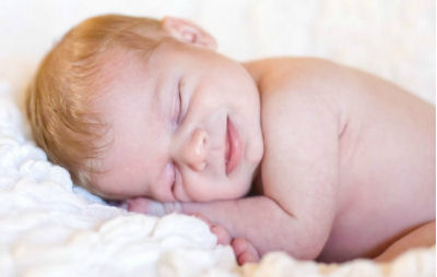 Smiling newborn baby portrait photographed by Lauren Glase