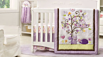 Purple and lavender forest theme nursery with baby crib bedding set with owls squirrels and hedgehogs