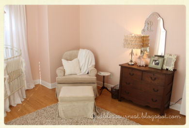 Antique white and pink baby girl nursery with vintage dresser