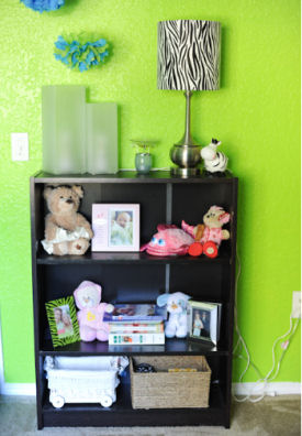 Nursery bookshelf with zebra print decorations