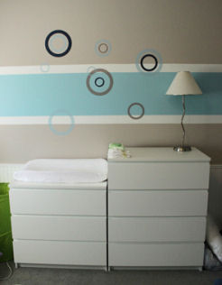 Modern white baby changing table in a baby boy nursery