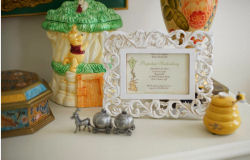 Matthews framed Winnie the Pooh baby shower invition included in a nursery tabletop arrangement