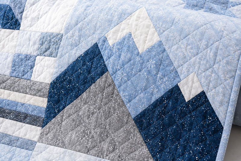 Detailed stitching closeup on mountain crib quilt pattern