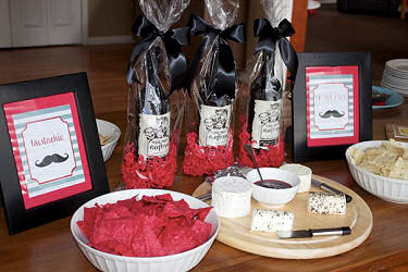Framed mustache art included on the snacks table at a baby boy's shower