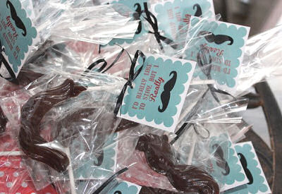 Mustache baby shower favors in goody bags decorated with personalized printable tags