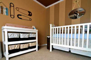 Woven storage baskets decorated with color-coordinated cloth for the baby's nursery room