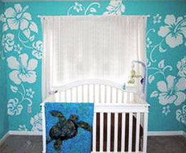 Hawaiian baby nursery theme design with hibiscus flowers painting on the wall and sea turtle baby bedding and applique crib quilt