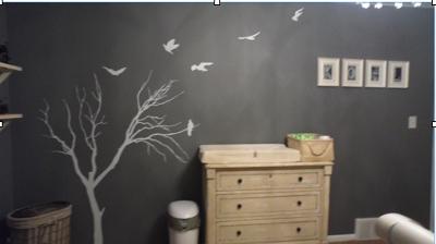 A wall decal featuring a tree with no leaves in winter with flying birds in our baby boy's nursery room.   