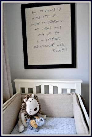 Framed embroidered Bible verse displayed over the crib in Owen's baby nursery room