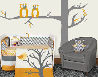 Yellow white and grey chevron owl baby bedding set in a nursery with a tree wall decal