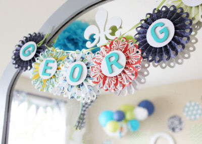 Baby Boy name  banner on the nursery wall made with rosette dies from Lifestyle Crafts