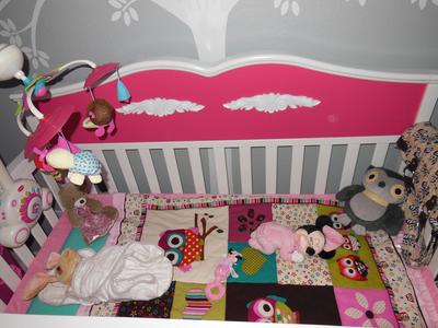 The patchwork baby crib quilt with owl theme appliques on the blocks and the mobile.   